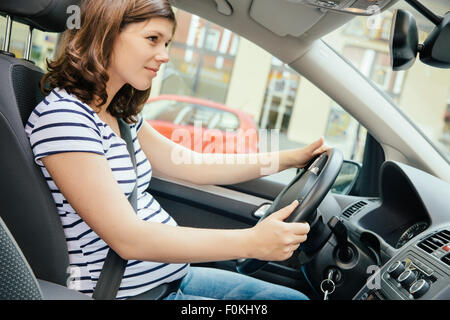 Pregnant woman driving car Stock Photo