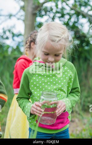 Germany, Children collecting worms in nature Stock Photo - Alamy