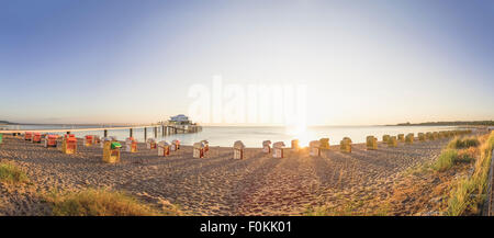 Germany, Niendorf, view to Timmendorfer Strand with hooded beach chairs and sea bridge Stock Photo