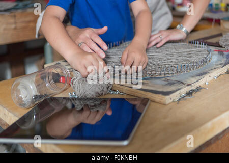 Mother and son doing crafts in home garage Stock Photo