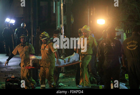 Bangkok, Thailand. 17th Aug, 2015. Thai rescue workers carry an injured person after an explosion Erawan shrine in downtown Bangkok at the Ratchaprasong intersection of Ratchadamri Road in Pathum Wan district. The bomb in Bangkok has resulted in multiple deaths and injuries. Credit:  Shaukat Ahmed/Pacific Press/Alamy Live News Stock Photo