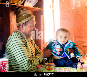 An old man playing with his grandson with copy space Stock Photo