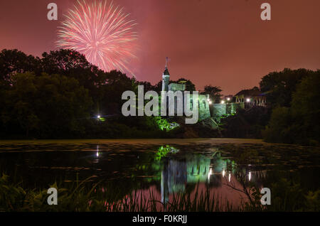 Fireworks explode over Belvedere Castle in Central Park in celebration of the New York Philharmonic's 50th anniversary. Stock Photo