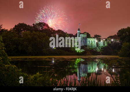 Fireworks explode over Belvedere Castle in Central Park in celebration of the New York Philharmonic's 50th anniversary. Stock Photo