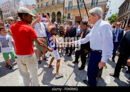 U.S. Secretary of State John Kerry greets residents of Old Havana during a tour through the Plaza de San Francisco August 14, 2015 in Havana, Cuba. The United States reopened the embassy in Cuba for the first time since 1961. Stock Photo