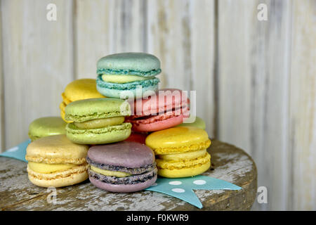 Stack of colorful French macaroons on polka dot ribbon. Stock Photo