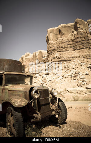 Old abandoned car at the Twin rocks in the Utah, toned image Stock Photo