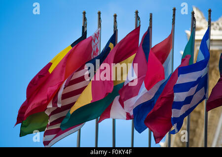 Group of flags of many different nations against blue sky Stock Photo