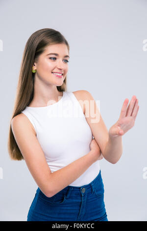 Portrait of a happy female teenager looking at her nails isolated on a white background Stock Photo