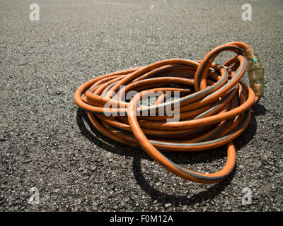 The Orange Extension Cord on the Ground at the Constructionsite Stock Photo