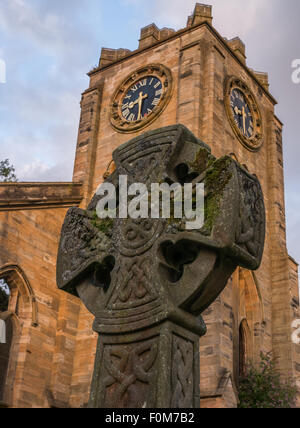 Lennoxtown Campsie High Church clock tower and a burial stone with celtic patterns or symbols Stock Photo