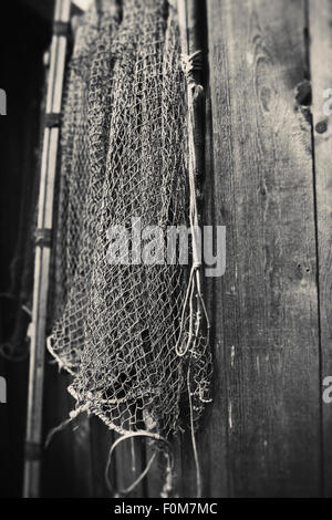 Old fishing nets hanging on wooden brown wall Stock Photo - Alamy
