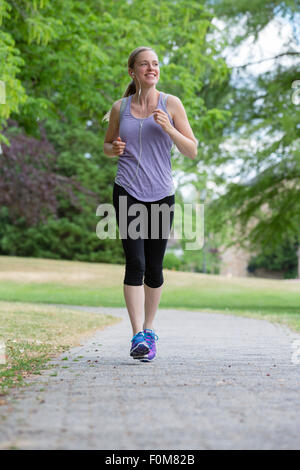 Woman jogging through the park