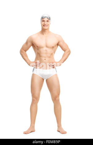 Full length portrait of a young handsome swimmer posing in white swim trunks isolated on white background