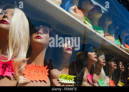 Close up of wigs hairstyles female mannequins mannequin on display in shop store window Stock Photo