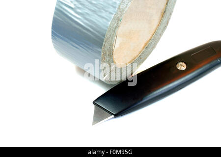 Roll of duct tape and knife isolated on white Stock Photo