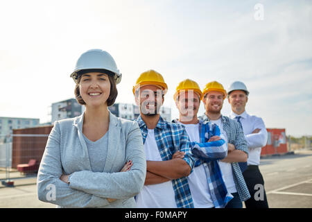 happy builders and architect at construction site Stock Photo