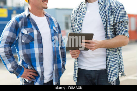 close up of builders with tablet pc outdoors Stock Photo