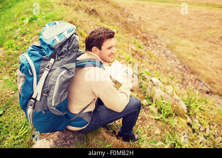 smiling man with backpack hiking Stock Photo