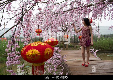 young girl in a plastic flower garden in Hanoi, Vietnam Stock Photo