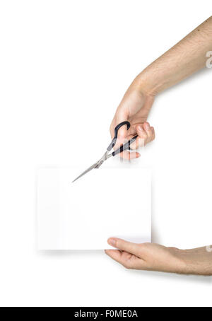 A woman is cutting a sheet of white paper using  metallic scissors, isolated on white background Stock Photo
