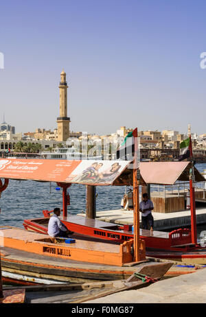 Old Souk Abra station with views over to the Grand Mosque Minaret, Dubai Creek, Deira, Dubai, UAE Stock Photo