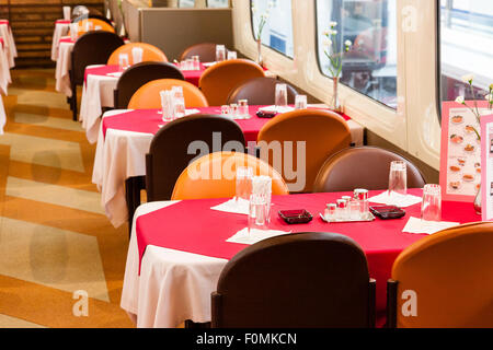 Japan, Nagoya, Railway park. Shinkansen Museum. Shinkansen 100 series, the interior of the restaurant carriage with tables laid with plastic food. Stock Photo