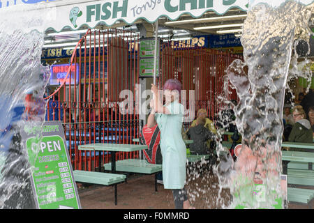 Skegness, Lincolnshire, UK. 18th Aug, 2015. Holiday makers and day-trippers make the best of the bad weather ,Heavy rain all day on the promenade resulting in empty beaches ,but indoor amusements are doing well . Credit:  IFIMAGE/Alamy Live News Stock Photo