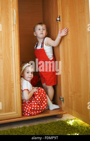 boy with girl playing hide and seek Stock Photo