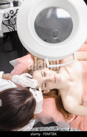 Young woman getting dermall fillers injection Stock Photo