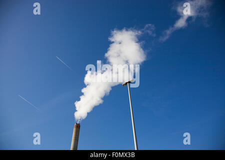 Waste recycling center in Brussels with white smoke coming out of the chimney, Belgium. Blue and clear sky in the background. Stock Photo