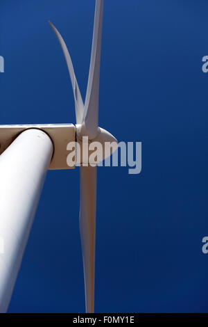 Wind turbine, close against blue sky Stock Photo