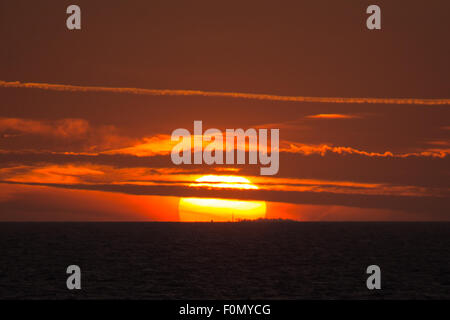 18th Aug, 2015. UK Weather: Sunset viewed from the deck of the Brittany Ferries M.V. Barfleur on its voyage to Poole in Dorset from Cherbourg in Normandy on Tuesday the 18th August 2015. Credit:  Chris Stevenson/Alamy Live News Stock Photo