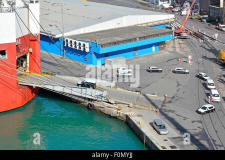 Aerial view looking down on Port of Koper new export cars being driven across dockside onto ramp to car carrier ship named Le Mans Express in Slovenia Stock Photo