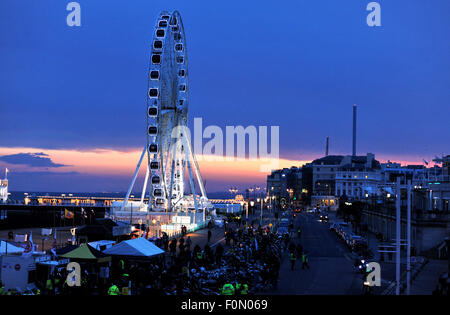 Brighton, UK. 18th August, 2015. A bright sunset drops behind the Brighton Wheel and the new i360 observation tower being constructed also on the seafront  Eventually the tower will be 450 feet tall and is due to open in the summer of 2016  Credit:  Simon Dack/Alamy Live News Stock Photo