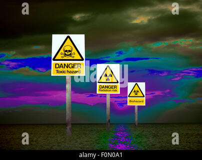 Three warning signs of health hazards and environmental dangers in a digital image illustrating a world of polluted air and sea. Stock Photo