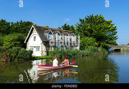 A couple rowing on the canal at bude in cornwall, uk Stock Photo