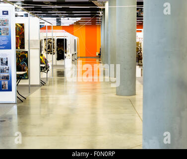Empty Art gallery with bright walls and hanging pieces of artwork Stock Photo