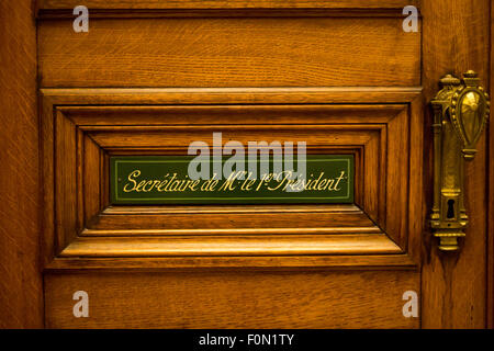 Classical style wooden door with sign saying: Secretary of the president written in French. Courthouse in Brussels. Belgium. Stock Photo