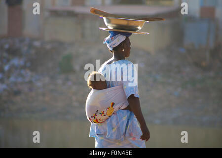 Unidentified Woman carrying a baby in her back in the streets of Mopti. 2010 Stock Photo