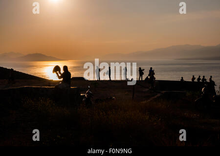 People at tropical beach before sunset. Stock Photo