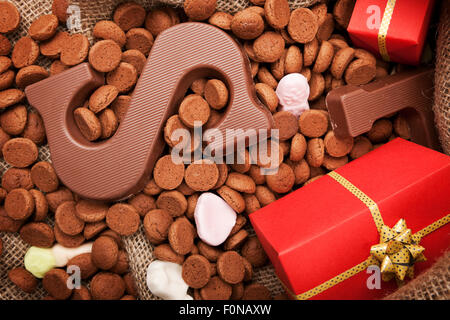 'De zak van Sinterklaas' (St. Nicholas' bag) filled with 'pepernoten', a letter of chocolate and sweets. All part of the traditi Stock Photo