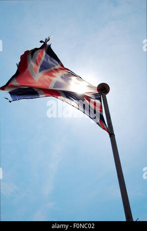 Ripped Union Jack Flag blowing in the wind Stock Photo - Alamy