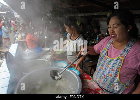 Local women preparing food at food stalls in the market, local market in Kyaing Tong, Shan State, Myanmar Stock Photo
