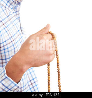 Close-Up of a hand holding a prayer chain Stock Photo