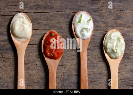 different types of sauces in spoons Stock Photo