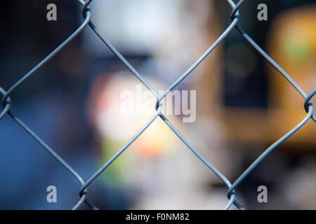 Cyclone fence in front of blurred out cityscpae Stock Photo