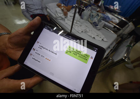 Bangkok, Thailand. 19th Aug, 2015. A volunteer displays WeChat chat logs among volunteers at the King Chulalongkorn Memorial Hospital in Bangkok, capital of Thailand, on Aug. 19, 2015. A total of seven Chinese nationals have been confirmed killed in a Bangkok explosion Monday night, the Chinese Embassy in Thailand said Wednesday. Another 26 Chinese were being treated in hospitals, the embassy said. Credit:  Li Mangmang/Xinhua/Alamy Live News Stock Photo