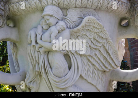 England, Kent, Hever, Hever Castle, The Italian Garden, Marble Urn with Angel Carrying Children Stock Photo