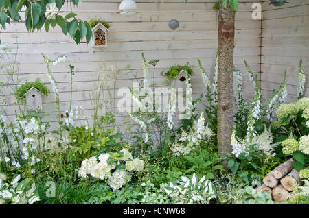 White bird boxes and insect hotel in Living Landscapes: City Twitchers garden at RHS Hampton Court Palace Flower Show 2015 Stock Photo
